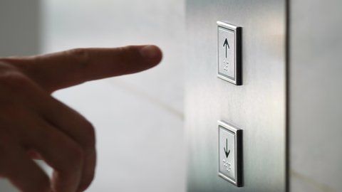 Man Pushing Elevator Button in Modern Building. Male Finger Pressing Lift Button Up. 4K Slow motion.