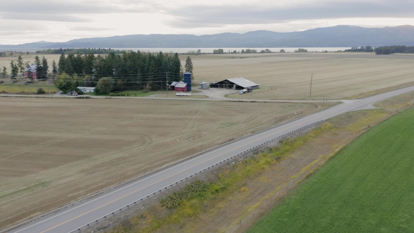Aerial: highway and ranch in Autumn. Big Fork, Montana, USA 