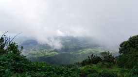 Timelapse - Clouds move over lush green mountain range. Western Ghats, Karnataka, India