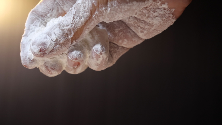 Flour falling from hand in 4K slow motion. Close-up of making and prepares flour for homemade bakery Royalty-Free Stock Footage #1043958550