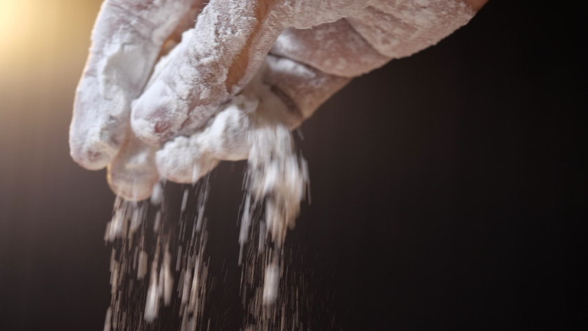 Flour falling from hand in 4K slow motion. Close-up of making and prepares flour for homemade bakery | Shutterstock HD Video #1043958550