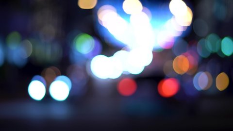 defocused night city street traffic lights. blurry glittering color bokeh of moving transport. blurred background