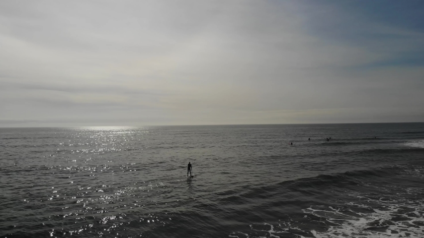 Drone at high altitude flying over the ocean with the view of a small island. Long Beach, CA
