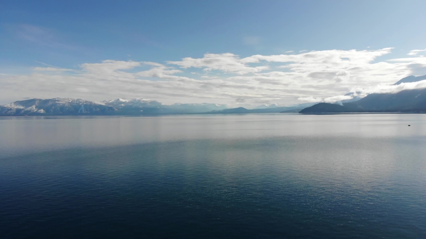 Drone at high altitude flying over the ocean with the view of a small island. Long Beach, CA