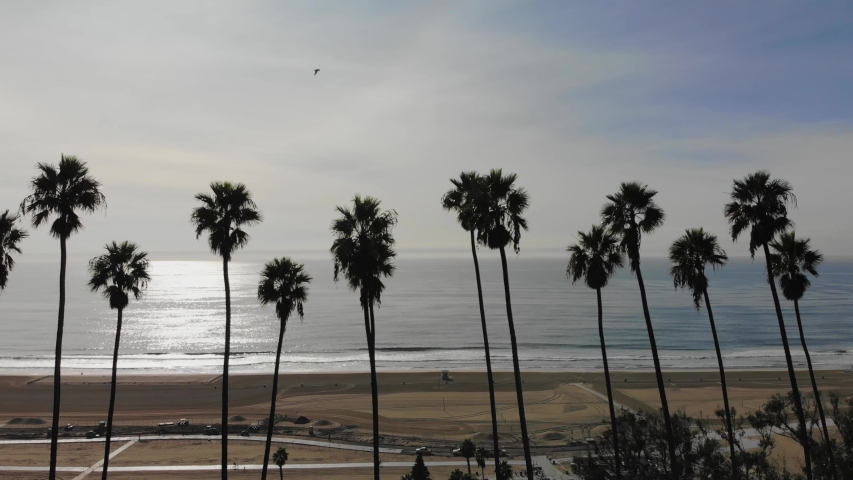 Drone at high altitude flying over the ocean with the view of a small island. Long Beach, CA
