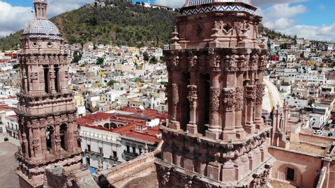 Zacatecas, Mexico 11/16/19 Aerial shot of the city of Zacatecas, in the foreground baroque style towers of the cathedral and in the background the hill of La Bufa and the cable car