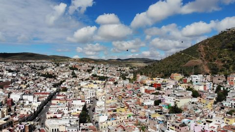 Aerial shot of the city of Zacatecas, in the foreground baroque style towers of the cathedral and in the background the hill of La Bufa and the cable car