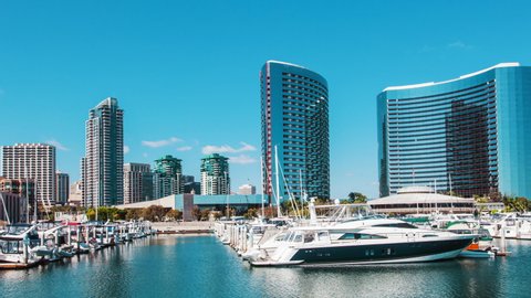 San Diego Marina with yachts and boats during the day and the city skyline during the day.