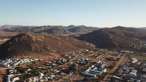 4K high quality sunny morning aerial panorama footage of spectacular scenic Springbok town, set among rocky mountains in Northern Cape province, South Africa near the border with neighbouring Namibia