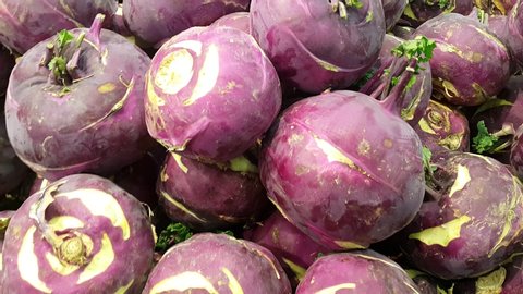 Closeup view of purple fresh kohlrabi turnip in supermarket for sale. Turnip is widely cultivated plant having a large fleshy edible white or yellow root