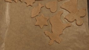 Freshly cut Christmas gingerbread cookie placed on baking tray. 4K resolution top view shot on a gimbal. Czech Republic