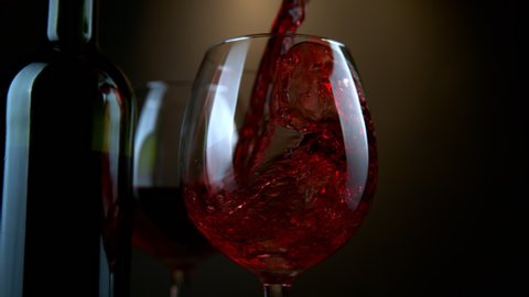 Super Slow Motion Shot of Pouring Red Wine from Bottle with Camera Rotation at 1000fps.