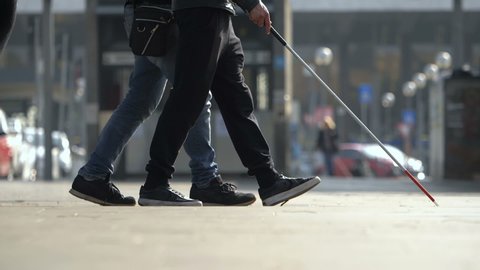 Assistance to Blind person. Man helping blind man walking in the city