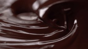 Chocolate. Mixing melted liquid premium dark chocolate. Close up of liquid hot chocolate swirl. Confectionery. Confectioner prepares dessert, sauce. slow motion 120 fps
