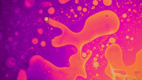 Fantastic structure of golden bubbles. Scientific experiment, chemical reactions. Chaotic motion, bubble flow expansion, curlicue of paints. Psychedelic liquid light show, ink patterns in water + oil.