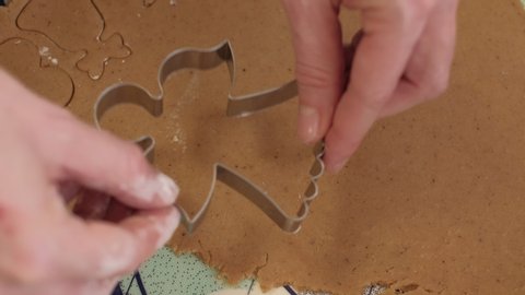 Cutting out Christmas gingerbread cookies in shape of an angel. 4K resolution close up shot on a gimbal. Czech Republic