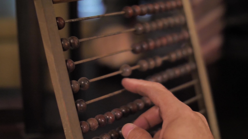 Man using vintage wooden abacus Royalty-Free Stock Footage #1044085123