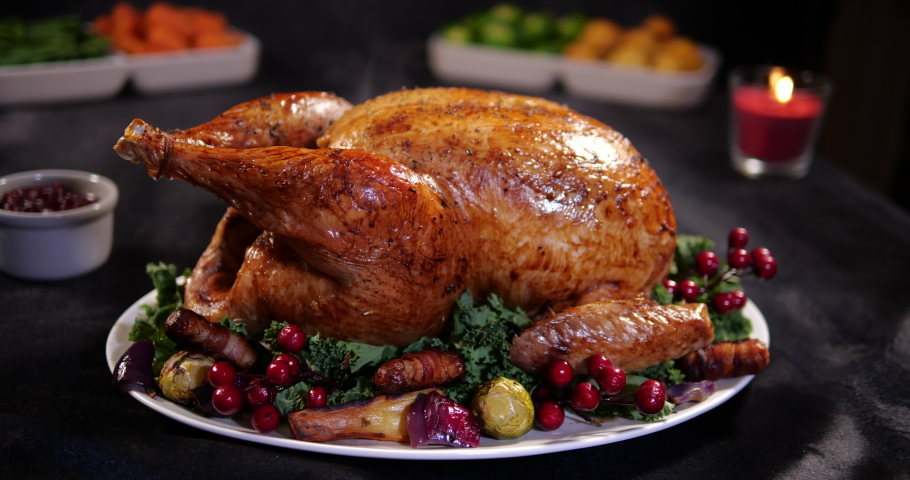 Christmas Turkey close up with vegetables for Xmas dinner. The roast is steaming and the clip has a camera dolly motion   -4K Stock Video clip footage