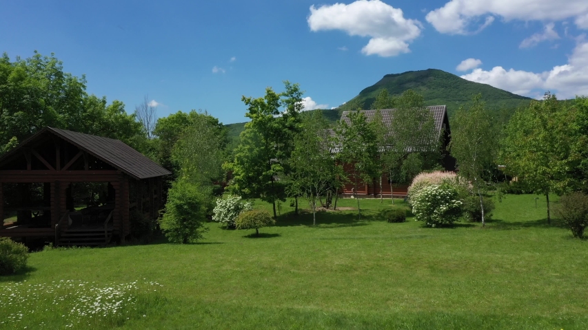 Beautiful houses in the mountains. A quiet place to live and relax, beautiful countryside among the trees, beautiful landscaping, flowers and green grass.