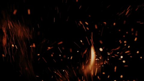 Hot flying embers and sparks in slow motion
