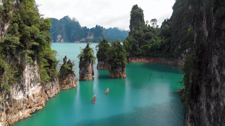 Khao Sok Lake Thailand Drone. Shot on DJI Mavic Air in the beautiful national park Khao Sok. The specific place is called Khao Sam Kloe. It is located in Ratchaprapha in the Cheow Lake in Thailand. Royalty-Free Stock Footage #1044097081
