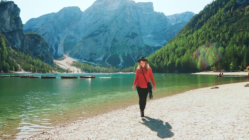 active happy joyful fun tourist woman smile face walks. Bright summer nature landscape Dolomites Alps Italy. enjoying vacation lake Braies. runs to camera raised arms hands. Girl model. Go Everywhere Royalty-Free Stock Footage #1044097225