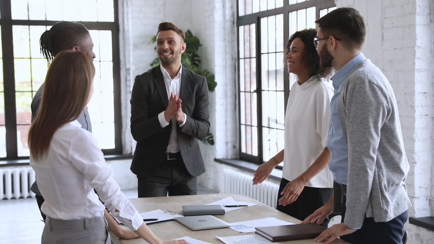 Successful male leader unite happy multiracial team people stack hands on table together promising support trust in partnership, help in collaboration, professional leadership concept, slow motion Royalty-Free Stock Footage #1044100564