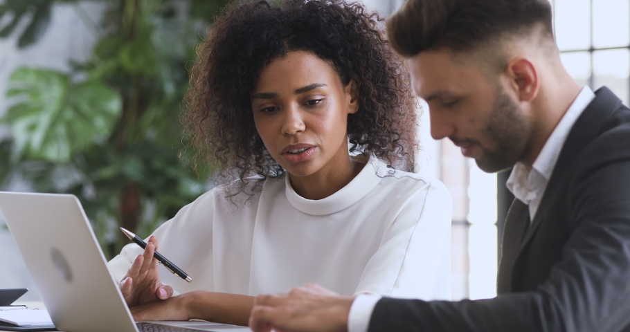 African female financial advisor agent lawyer insurer consulting caucasian male client customer explaining insurance contract benefits negotiating discuss agreement at business meeting legal advice Royalty-Free Stock Footage #1044100576