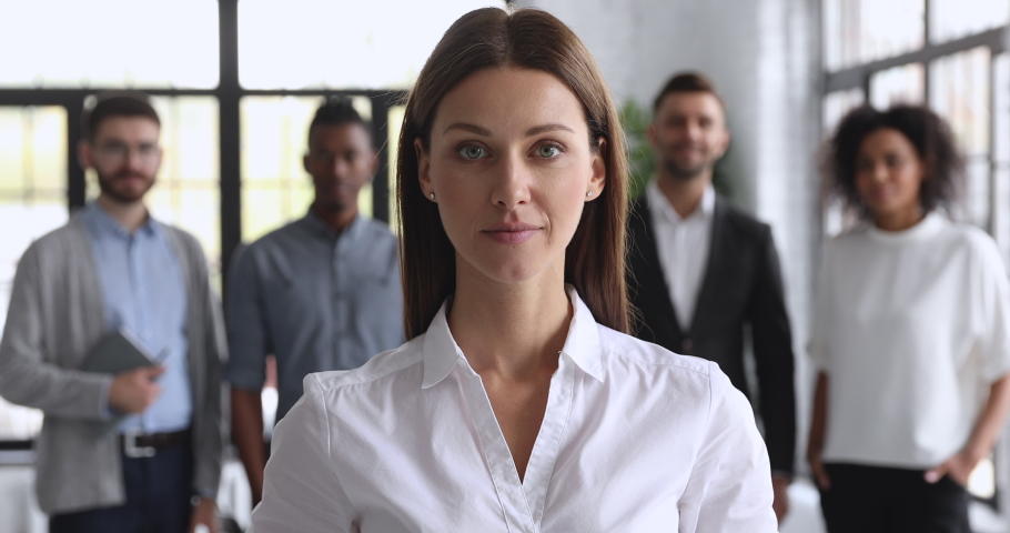 Smiling attractive young female business leader look at camera show thumbs up, happy businesswoman professional manager executive proud satisfied with career in corporate office, closeup portrait Royalty-Free Stock Footage #1044100609