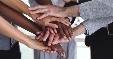 Corporate business team people group stack hands together in pile close up view building strong reliable team helping in teamwork express strength power of partnership professional leadership concept