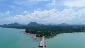 Drone flying shot of Bridge in to the tropical sea and small island in summer time location of koh rat suratthani thailand	