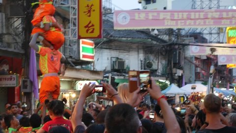 Bangkok, Thailand-February 6, 2018: Kids and adults perform do a pyramid of acrobat during Chinese New Year in Chinatown