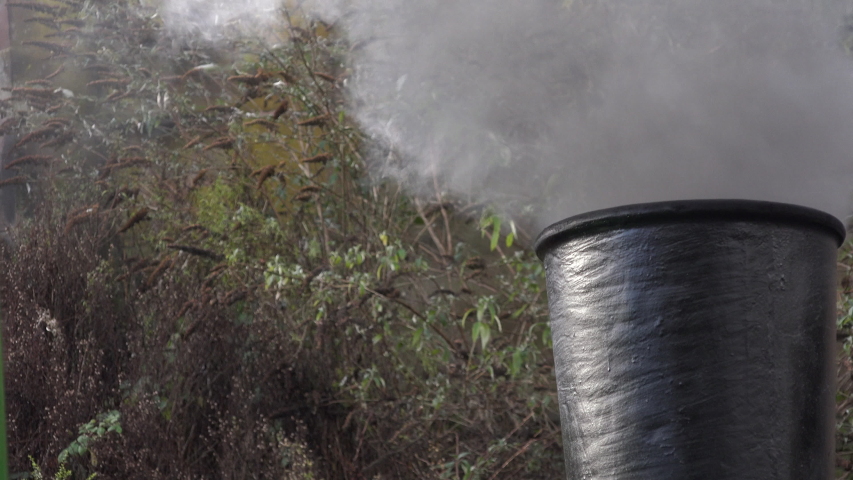 Close up of smoke coming out of steam engine funnel and chimney. Locomotive  engine in England UK 4K