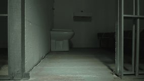 Empty Prison cell - Close up. The Jail door closes and the iron bars create a long shadow.   -4K Stock Video clip footage