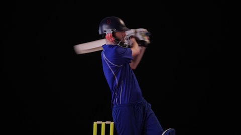 Cricket Batsman hitting the ball - Pull shot. Black background. Dressed in blue  -4K Stock Video clip footage