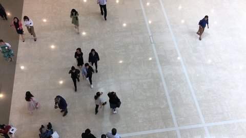 HONG KONG - SEPTEMBER 2019: Top view of people walking in the IFC Mall, a 4 storey shopping mall with many luxury retail brands and wide variety of restaurants.