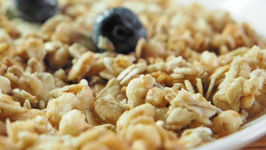 Blueberry falling down to flakes, slow motion, close up, slow motion video