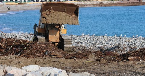 Menton, France - January 6, 2020: Liebherr LR 634 Track Loader Cleaning Debris On The Beach After A Winter Storm In Menton, France, French Riviera, Europe. Close Up View - DCi 4K Resolution