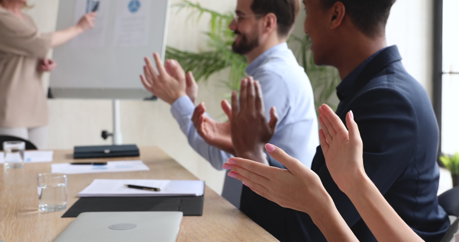 Diverse business people corporate team professional audience group sit at conference table clap hands at presentation give applause at training meeting, corporate achievement success concept close up Royalty-Free Stock Footage #1044147538