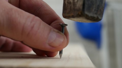 Worker Mistake Trying to Fix a Plank with a Nail and a Hammer