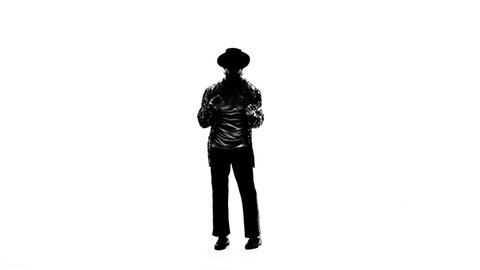 Silhouette of a young man dancer dancing in style Michael Jackson on white background.