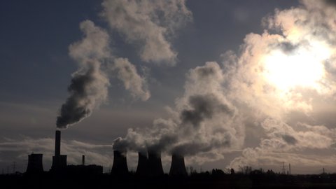 Coal fired power station pumping out smoke and steam. Global warming pollution in Manchester England UK 4K