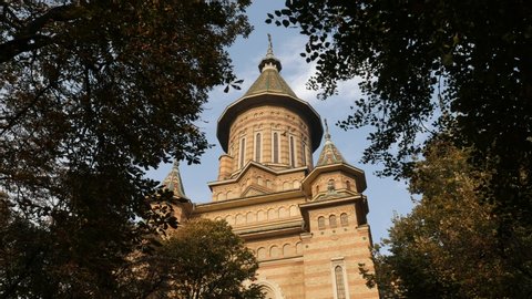 Orthodox Metropolitan church in Timisoara Romania through tree crowns 4K footage