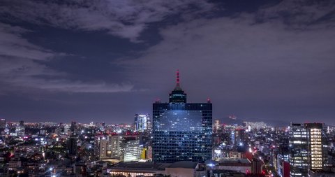 Aerial time lapse of the world trade center building at night in the south of mexico city , many clouds, lights, buildings and skyscrapers in the skyline.