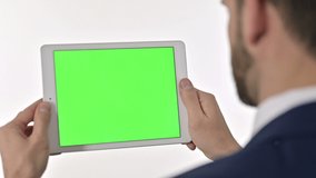 Businessman watching Video on Tablet with Chroma Screen, White Background