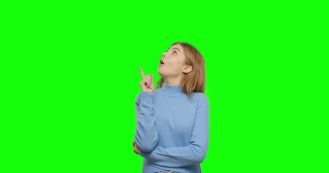 Thinking girl showing thumb up. Young pretty woman on green screen background, Chroma Key 4k video footage slow motion 60 fps