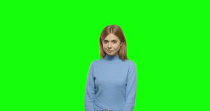 Shy girl smiling. Young pretty woman on green screen background, Chroma Key 4k video footage slow motion 60 fps