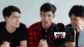 Group of three handsome Asian influencers on-air their live video to their channel for reached to their followers.

