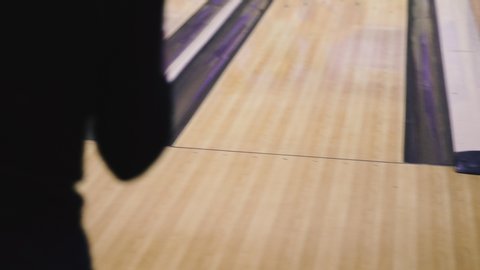 Bowling. A bowling player knocks out a strike.