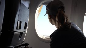 Girl Looking Through Airplane Window And Audio Video